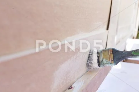 Paintbrush painting white on wood fence Stock Photos
