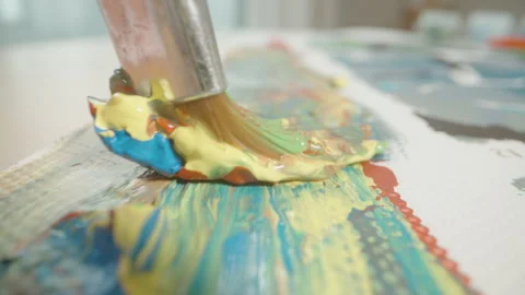 Paintbrush Pulling Paint Through Blue Yellow Orange Mixture in Macro Close-Up Stock Footage 306494300