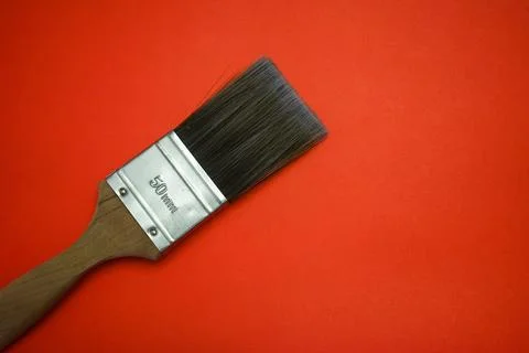 Paintbrush on red color background Stock Photos