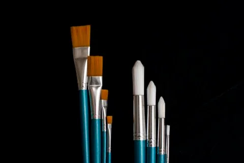 Paintbrushes on dark background Stock Photos