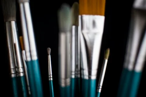 Paintbrushes on dark background Stock Photos