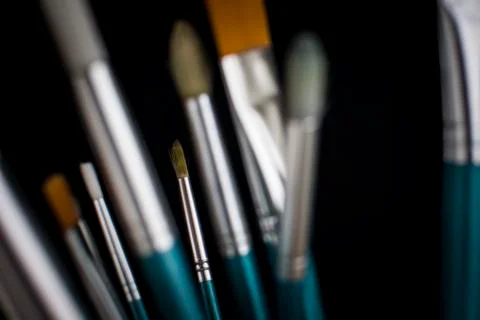 Paintbrushes on dark background Stock Photos