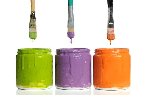 Paintbrushes Dripping Paint into Containers Stock Photos