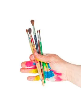 Paintbrushes in hand Stock Photos