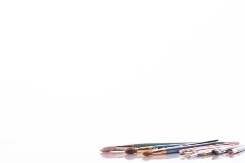 Paintbrushes Set on white glossy surface. art exhibition invitation card mock-up Stock Photos
