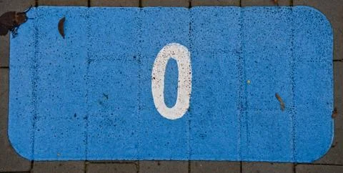 Painted 0 zero on a pavement blue background Stock Photos