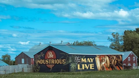 Painted barn in field with clouds time lapse - Canada Stock Footage 127391735