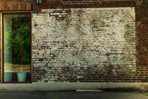 Painted brick wall with an large window Foto stock