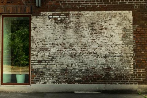 Painted brick wall with an large window Foto stock