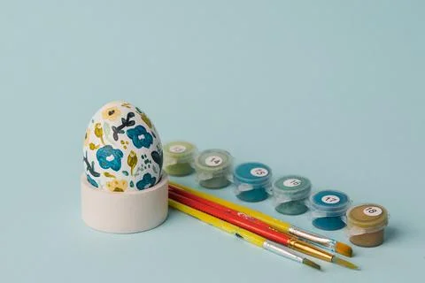 Painted chicken egg in floral pattern. DIY craft for easter holidays with kids Stock Photos