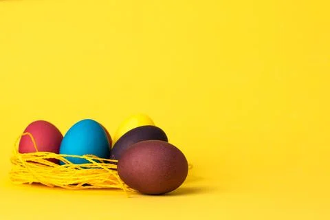Painted chicken eggs on a yellow background. Easter eggs. copyspace Stock Illustration