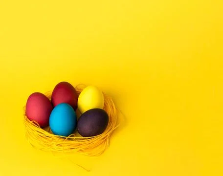 Painted chicken eggs on a yellow background. Easter eggs. copyspace Stock Illustration
