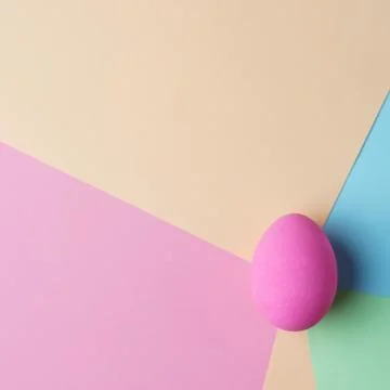 Painted colored easter egg on pastel background Stock Photos