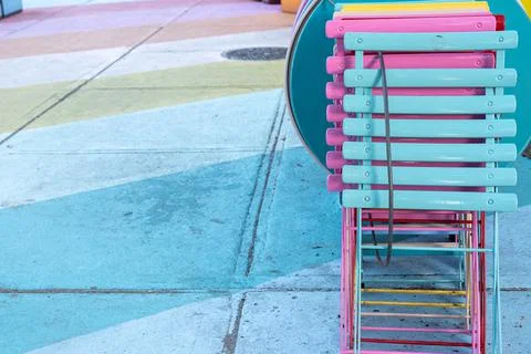 Painted colorful stripes on the ground outside. Various colors of folding chairs Stock Photos