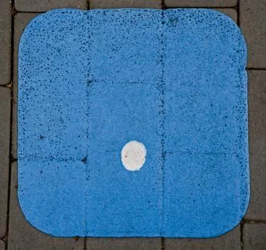 Painted dot . on a pavement blue background Stock Photos