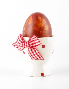 Painted Easter egg in the egg cup on the white background Stock Photos