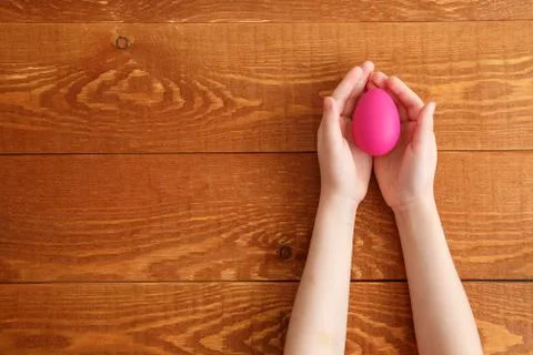 Painted Easter Egg In Hands Wooden Background Stock Photos