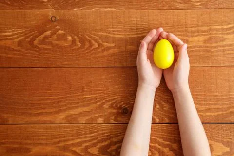 Painted Easter Egg In Hands Wooden Background Stock Photos