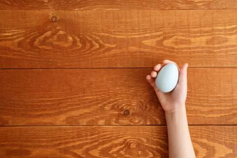 Painted Easter Egg In Hands Wooden Background Stock Photos
