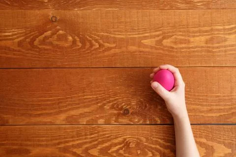 Painted Easter Egg In Hands Wooden Background Stock Photos