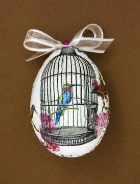 Painted Easter egg with the hummingbird in the cage Stock Photos