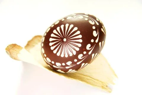 Painted easter egg on a slice of wood isolated on white Stock Photos