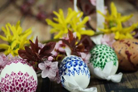 Painted Easter eggs and grass with cherry branch Stock Photos