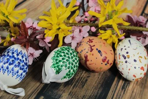 Painted Easter eggs and grass with cherry branch Stock Photos
