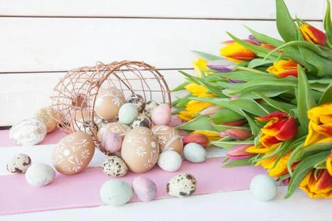 Painted easter eggs and tulips Stock Photos
