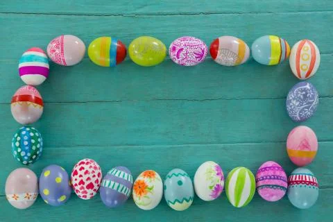 Painted Easter eggs arranged in rectangle shape on wooden plank Stock Photos