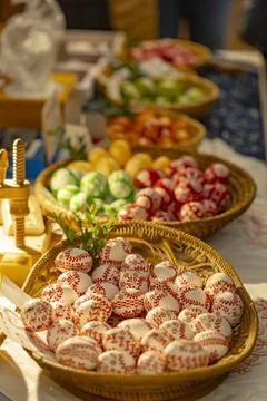 Painted Easter eggs in baskets on display at a market Stock Photos