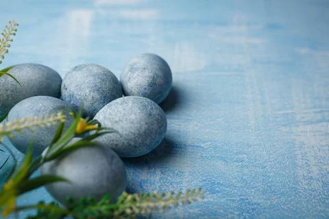 Painted Easter eggs on blue background with yellow flowers. Spring holiday Stock Photos