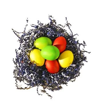 Painted Easter eggs in blue paper bird nest on white Stock Photos