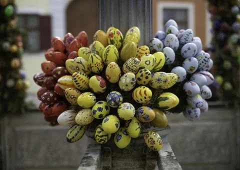 Painted Easter eggs in blue yellow and white with flowers and other decoratio Stock Photos