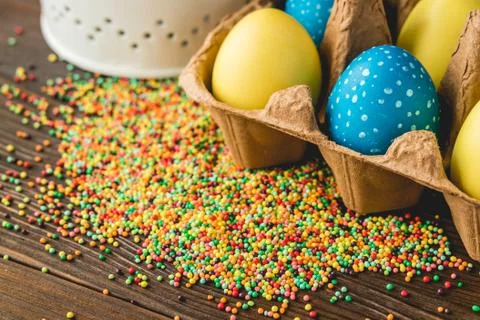 Painted Easter eggs in a box on a wooden table Stock Photos