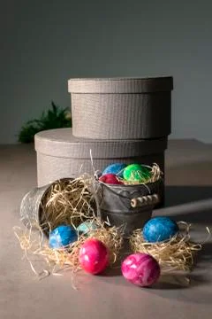 Painted easter eggs with buckets and round boxes Stock Photos