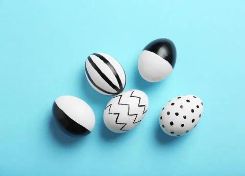 Painted Easter eggs on color background, top view Stock Photos