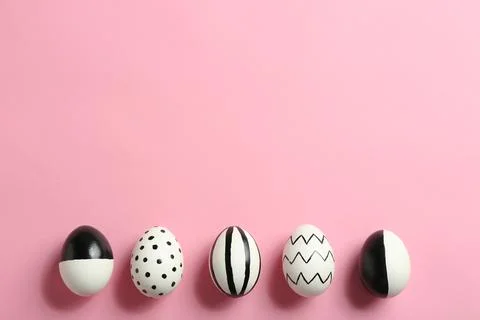 Painted Easter eggs on color background, flat lay with space for text Stock Photos