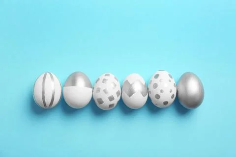 Painted Easter eggs on color background, top view Stock Photos
