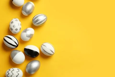 Painted Easter eggs on color background, top view with space for text Stock Photos