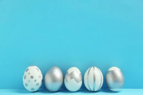 Painted Easter eggs on color background, space for text. Stylish design Stock Photos