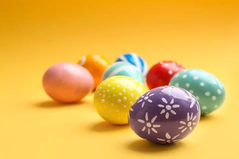 Painted Easter eggs on color background, space for text Stock Photos