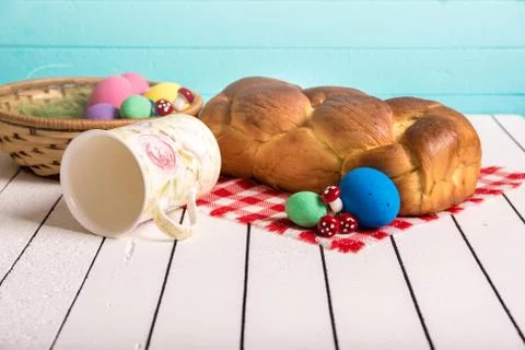 Painted Easter eggs, delicious cake and cup for milk on a wooden background. Eco Stock Photos