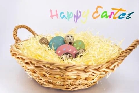 Painted Easter Eggs in a Farm Basket and Text in English Happy Easter Stock Photos