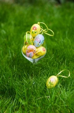 Painted easter eggs in glass on green grass Stock Photos
