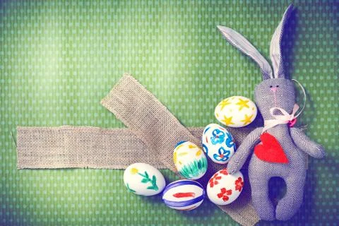 Painted Easter eggs on a green background with white polka dots Stock Photos