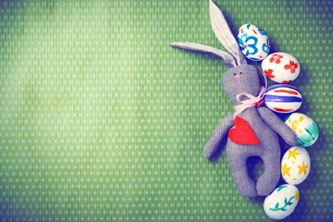 Painted Easter eggs on a green background with white polka dots Stock Photos