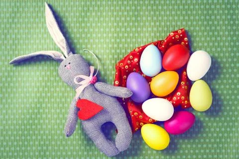 Painted Easter eggs on a green background with white polka dots Stock Photos