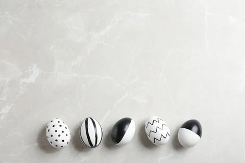 Painted Easter eggs on grey background, flat lay with space for text Stock Photos
