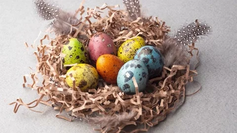 Painted Easter eggs jump into a nest of kraft paper, close-up. Stock Footage 151254131